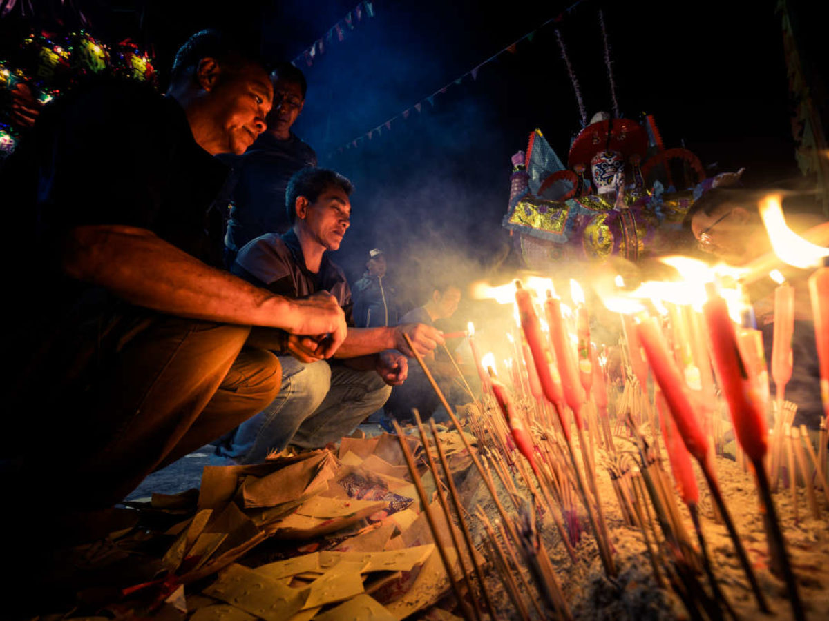 Family gathering with offerings for hungry ghosts during the festival