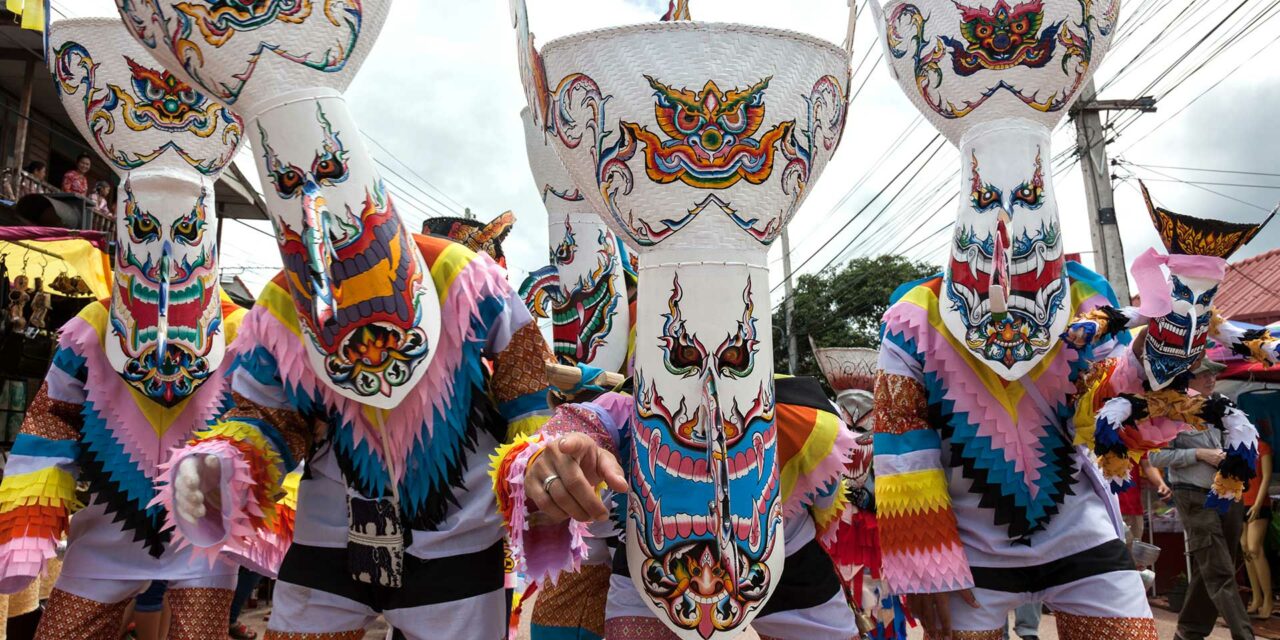 A group at the Phi Ta Khon festival displays their ghost masks during a spirited procession.