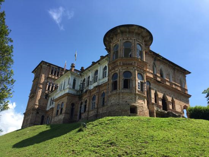 Kellie’s Castle at twilight, emphasizing its ghostly aura and historical significance.