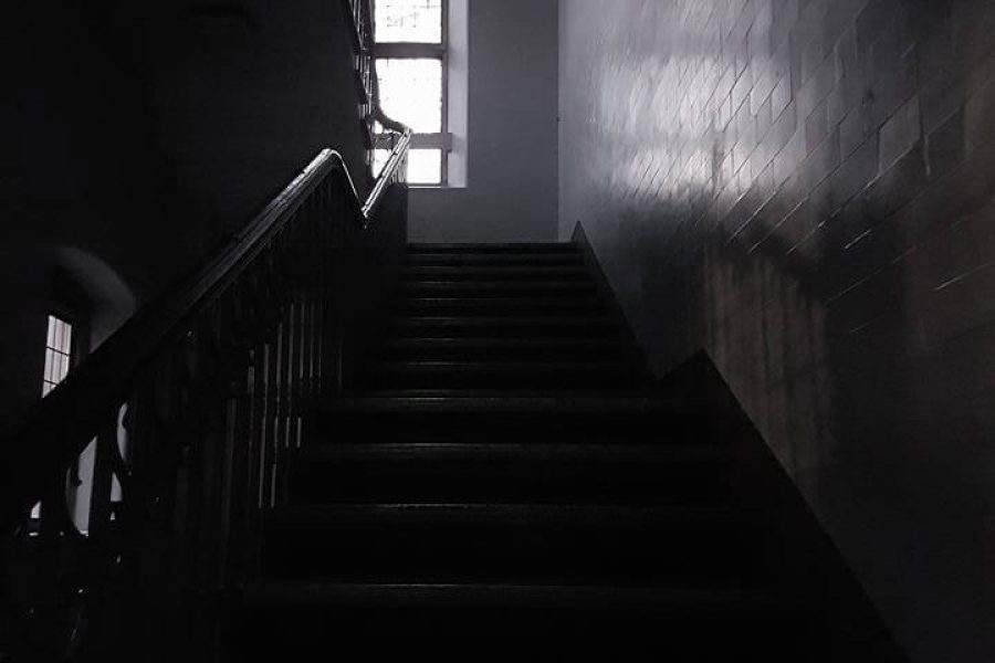 An exterior view of a haunted school setting in a dark atmosphere