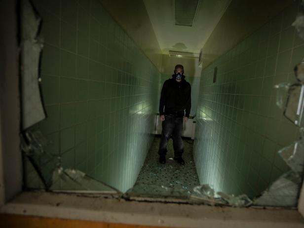 Eerie hallway of an abandoned hospital, conveying a sense of supernatural presence.