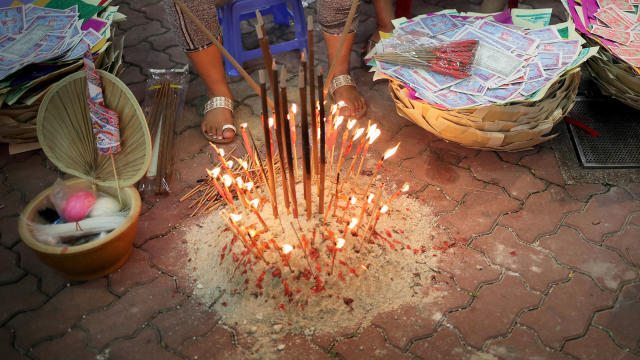 Burning incense and joss paper offerings during Hungry Ghost Festival in Singapore