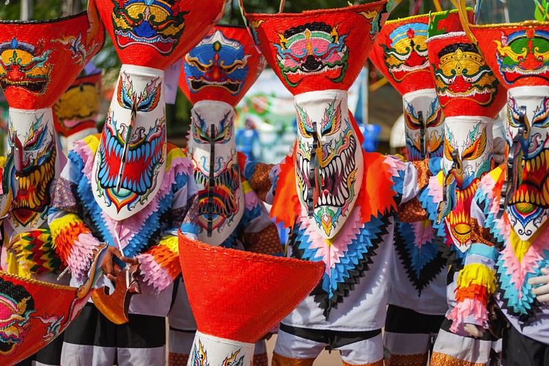 Dancers in spirited costumes celebrating at the Phi Ta Khon Festival