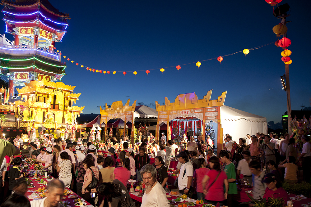 The lively activities characteristic of the Ghost Month celebrations in Taiwan, interacting with ancestral spirits.