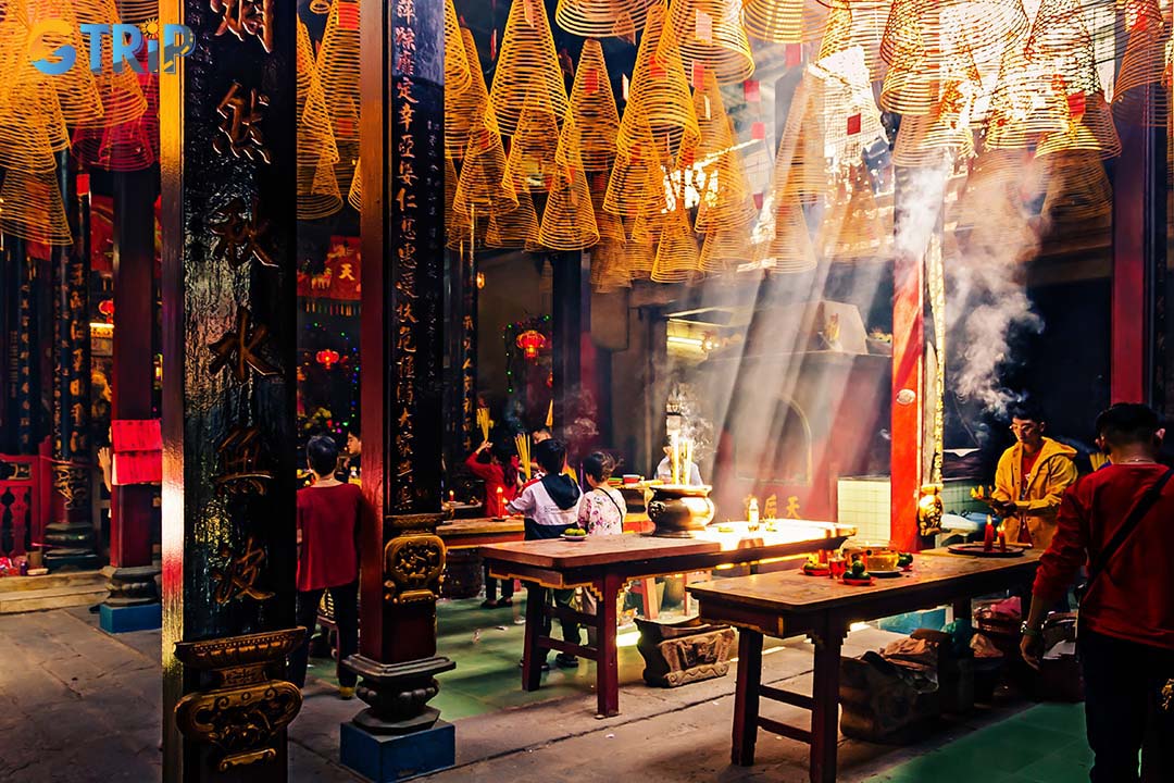 A vibrant celebration scene depicting offerings for the spirits in Ghost Month