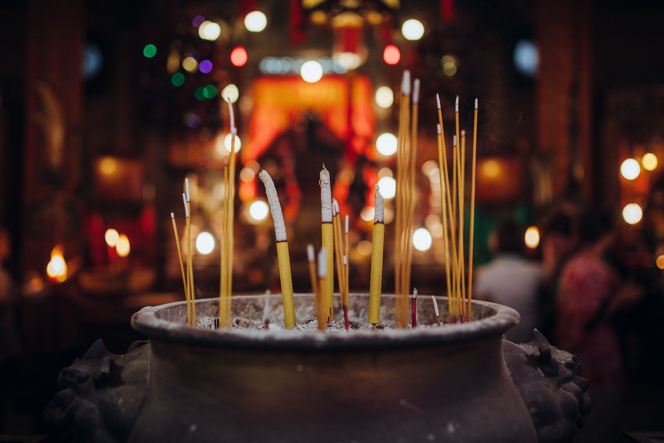 Incense smoke swirling out of a joss stick in an incense pot, representing offerings during the Ghost Month.