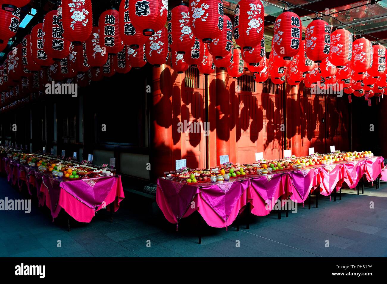 Tables with offerings and red hanging lanterns for the Hungry Ghost Festival