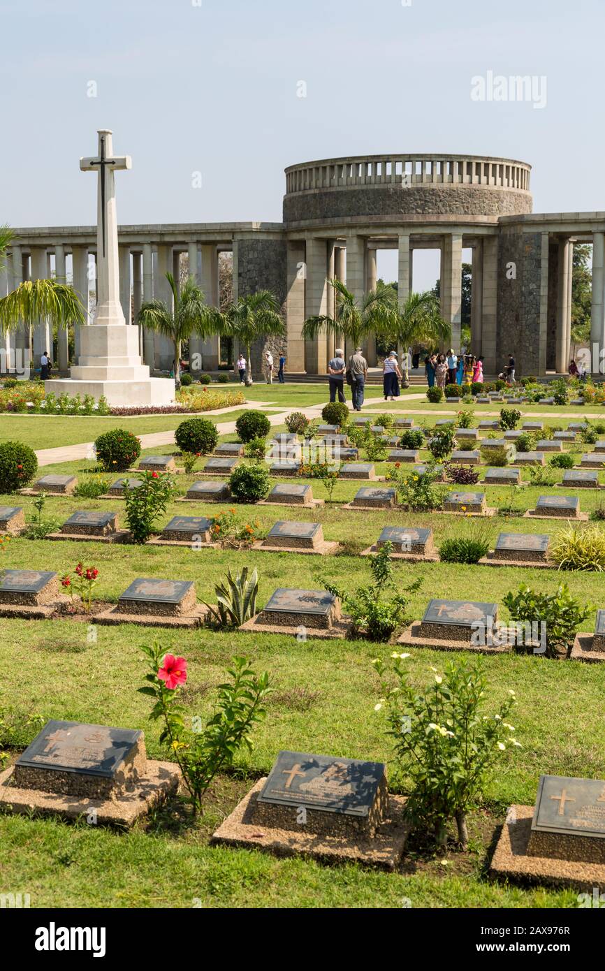 An encompassing perspective of Taukkyan War Cemetery providing insight into the burial grounds, interspersed with flowers—reminders of veneration in local traditions.