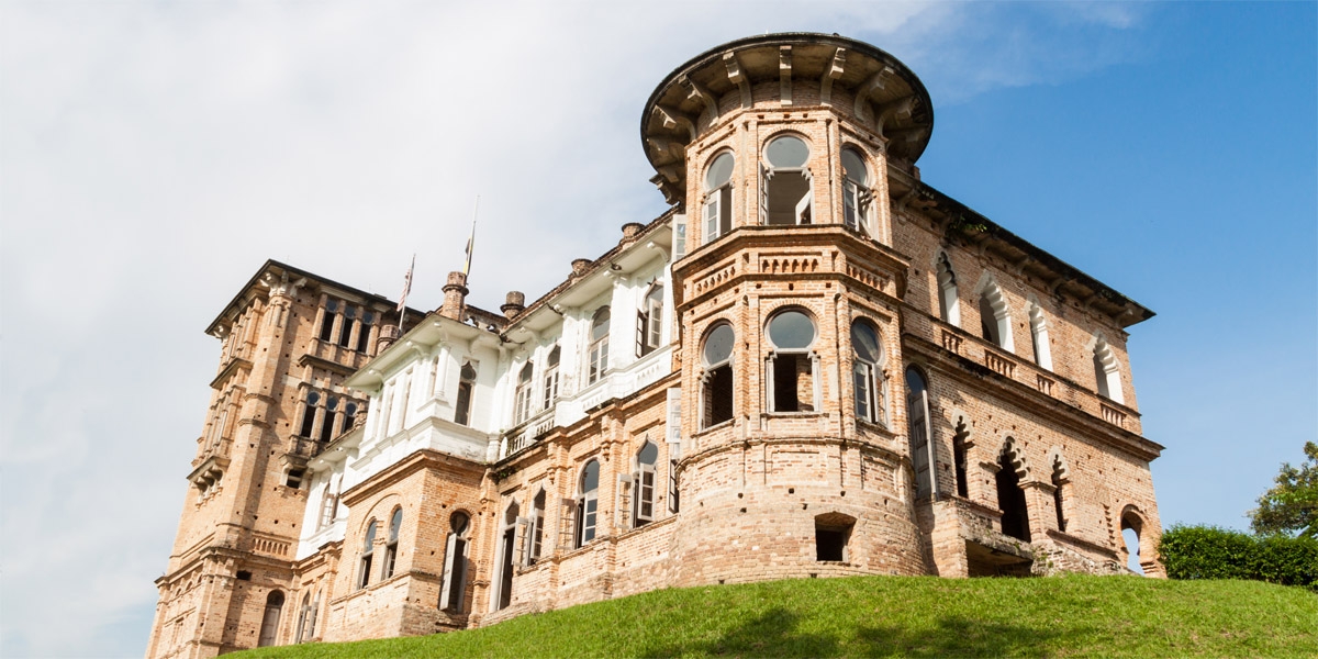 A hauntingly beautiful view of Kellie's Castle, highlighting its gothic architecture and the mysteries it holds in the shadows.