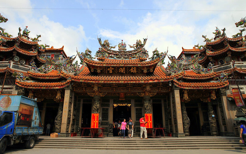 An intricate detail from the Dajia Mazu Pilgrimage, encapsulating devotion and religious respect intertwined with the moody atmosphere of the festivities.