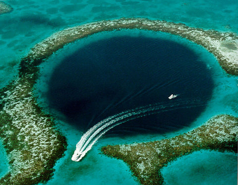 A visually mesmerizing Blue Hole underwater in the ocean showcasing the beauty and depth of marine exploration.